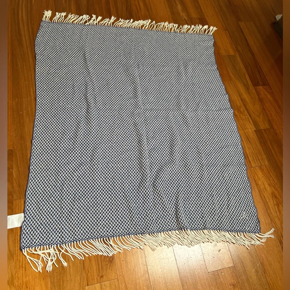 West Elm soft Navy and White Fringe Throw Blanket with embroidered “H” emblem